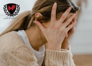 Female holding her head in her hands with worry