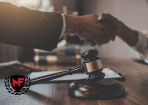 Lawyer and Victim shaking hands over a gavel.